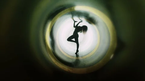 4K Silhouette of beautiful sexy girl , woman dancing inside circle tube . Stock Footage