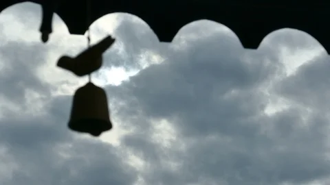 4K silhouette bell on blue cloud rainny sky. Abstract sadness moment Stock Footage 99496265