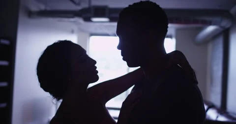 4k Silhouette of Black and Latin couple kissing and embracing in apartment Stock Footage