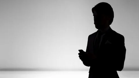4K Silhouette Corporate Man Using Mobile Smartphone for Business Young Success Stock Footage 81078097