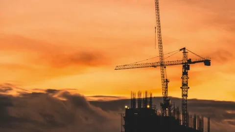 4K Silhouette of Tower Crane on Construction Site Against Orange Sun Stock-Footage 332157211