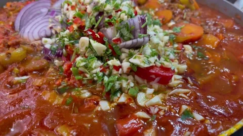 4K simmering Bolognese with last batch of aromatic and spices added Stock Footage 222345698