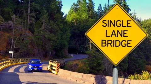 4K Single Lane Bridge, Yellow Diamond Sign, Yellow Traffic Signal Stock Footage 66690617