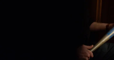 4k Sinister vicar holding a baseball bat with serious expression Stock Footage 128401033