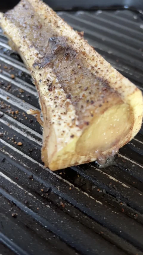 4K sizzling grilled beef bone marrow just out of oven Stock Footage 251180307