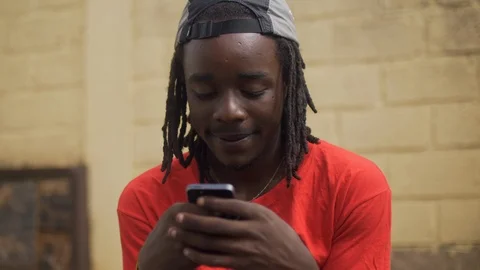4k skateboarder using his cell phone sitting on the ramp of the road Stock Footage 112997107