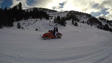 4k ski skiing snowmobile passing by trees snow mountains resort holidays Video stock 57315527