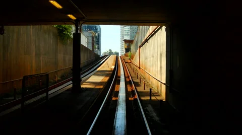 4K Skytrain Train Tunnel Opens Up to Daylight and City View Stock Footage 65573712