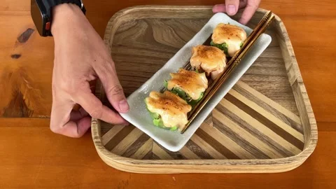 4K Slo Mo Cinematic: Serving a Plate of Delicious Mentai Dimsum on Wooden Tray Stock Footage 338278363