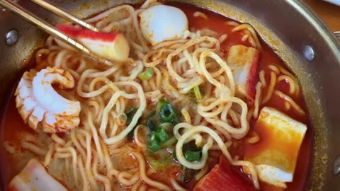 4K Slo Mo Close-Up: Chopsticks Picking Fish Cake from Hot Tom Yum Soup Stock Footage 338278708