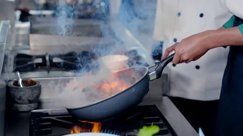 4K Slow, Close-up pan that burns all over because chef's technique lifting .. Stock Footage 237587659