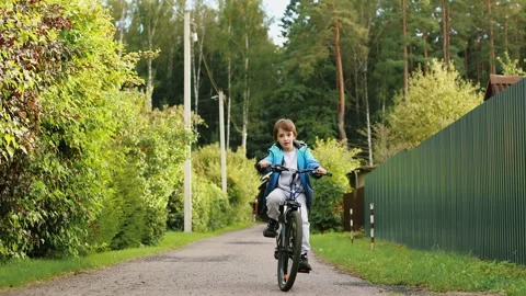 4K slow motion 60 fps footage of a cute focused little boy in a blue jacket r Stock Footage 344880623