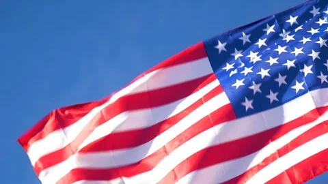 4k Slow Motion American Flag Blowing in Wind Blue Sky Afternoon Stock Footage 100272540