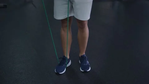 4k Slow Motion Athlete Warms Up with Rubber Band Stock Footage 185157593