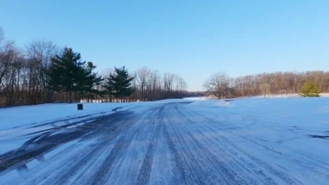 4K Slow Motion Back Shot of Car Driving in Winter Wonderland with Snow and Sun Stock Footage 300148240
