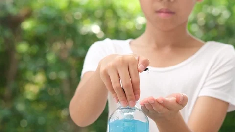 4k slow motion camera panning, close up focus at kid hands using alcohol gel Stock Footage 125896036