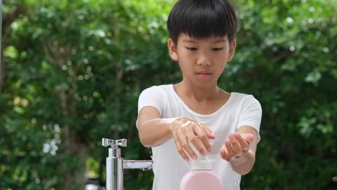 4k slow motion camera panning, young Asian boy use bubble soap to wash hand  Stock Footage 125896069