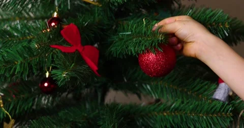 4K Slow Motion of a Child’s Hand Decorating a Christmas Tree Stock Footage 292445779