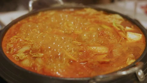 4K Slow motion Close-up of Korean army stew or Budae Jjigae bubbling and boil Stock Footage 337835617