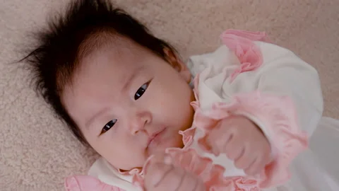 4K Slow Motion, Close Up Portrait of a black-haired 3-month-old newborn Stock Footage 203893986