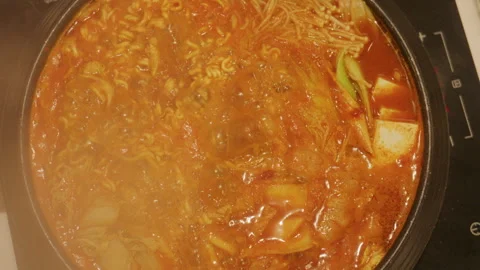 4K Slow motion Close-up top view of Korean army stew or Budae Jjigae bubbling Stock Footage 337835663