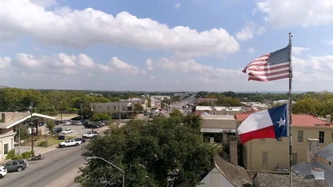 4K Slow Motion Drone Texas Flag American Flag Fredericksburg Video stock 118398114