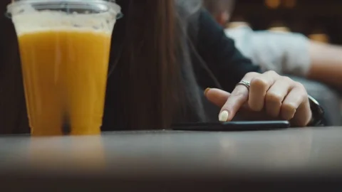 4k slow motion. Elegant young woman browsing on smartphone in cafe on table Stock Footage 78257681