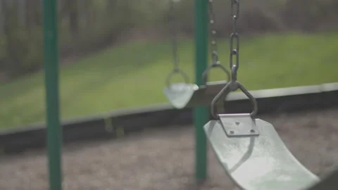 4K Slow motion footage of empty swings in playground (Raw/ungraded) Stock Footage