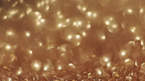 4K slow-motion golden glitter bokeh, soft focus shifts for a festive effect. Stock Footage 292686735