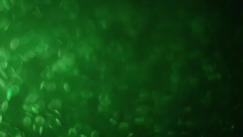 4K slow-motion green glitter bokeh, with soft focus shifts, festive feel Stock Footage 291890510