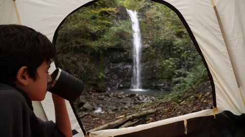 4k, slow motion. A hand holding a mug against the background of a view of the Stock-Footage 82444662