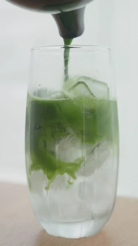 4K Slow Motion Homemade Refreshing Iced Matcha Coconut Water Stock Footage 340996507