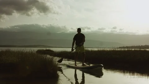 4K  Slow Motion: Man Stand Up Paddling Through The Swamp Stock Footage 93073714
