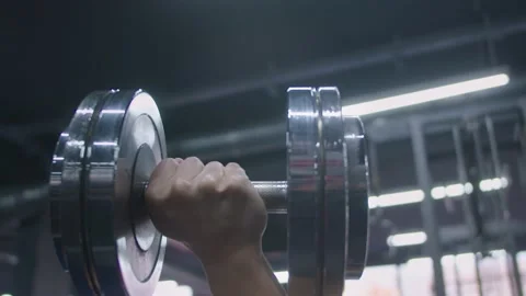 4k Slow Motion Moving Close Up of Dumbbell Weights being lifted in gym. Stock Footage 185158458