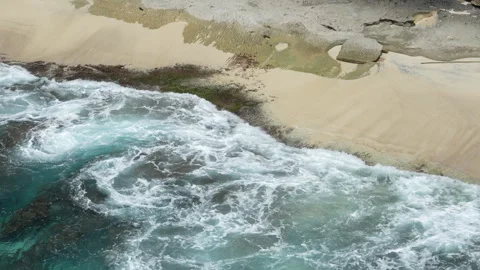 4K slow motion of ocean waves crashing on sandy shore inside Broken Beach 스톡 동영상 337086947