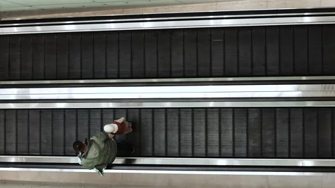 4K slow motion overhead view of people riding an escalator in a modern public 스톡 동영상 327239471