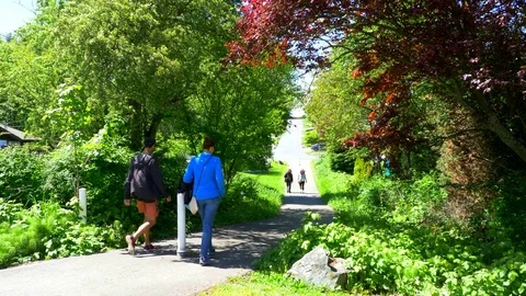4K Slow Motion People Talking through City Park Path in Spring, Happy Lifestyle Stock Footage 76276301