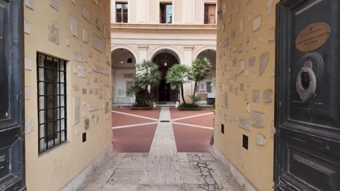 4K Slow Motion Perspective Moving Through Antique Gate Into Sunny Courtyard Video stock 333263447