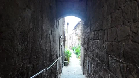 4K Slow Motion Perspective Under Medieval Stone Arches Viterbo Stock Footage 332871367