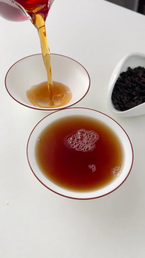 4K slow motion pouring tea from clear glass pitcher teaware into white cups, cre Stock Footage 299725136