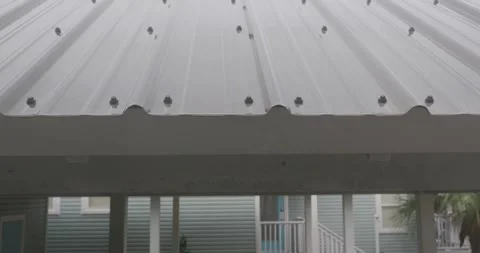 4K Slow Motion Rain Dripping onto and off of metal roof during storm Stock Footage 251024375