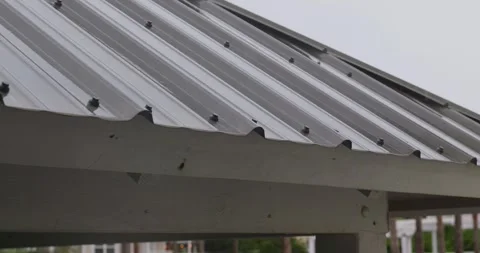 4K Slow Motion Rain Dripping onto and off of metal roof during storm Stock Footage 251024487