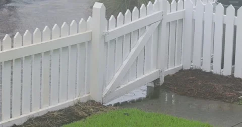 4K Slow Motion of Rain in Puddles around Fence Gate Stock Footage 251024479