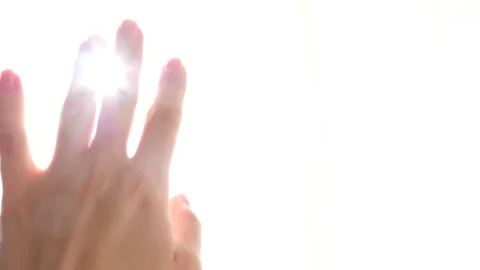 4k, slow motion. rays of the sun, passing through the fingers of a woman's hand Stock Footage 82142165