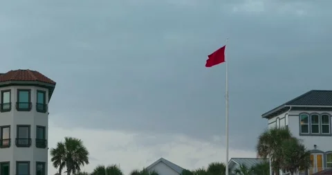 4K Slow Motion Red Flag flying on Beach Stock Footage 251024508