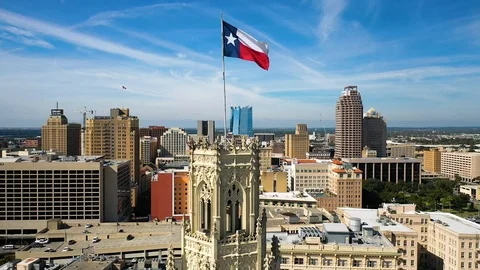 4K Slow Motion Rising Drone San Antonio Tx Skyline Texas State Flag Blue Sky Stock Footage 119724003