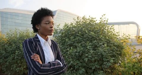 4k. Slow motion. Serious prety Afro-American businesswoman crosses her arms on Stock Footage 98296464