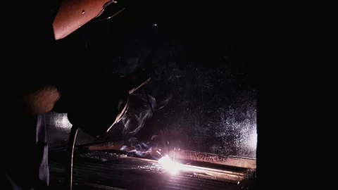 4K Slow motion shot of Blacksmith holding electrode and welding mask and weld Stock-Footage 102572416