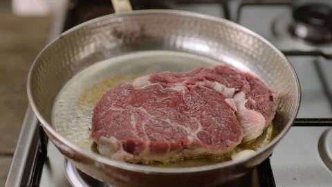 4K Slow Motion Shot of Cooking Meat in a Copper Pan Stock Footage 115863533