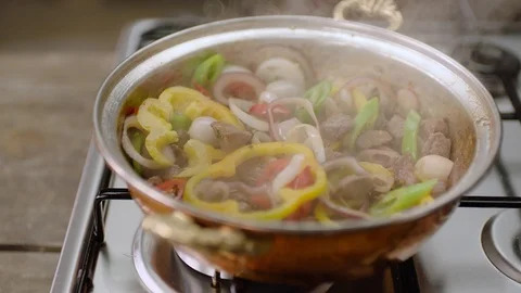 4K Slow Motion Shot of Cooking Meat in a Copper Pan Stock Footage 121829675